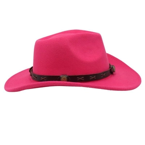 Detail of bright pink cowboy hat featuring a faux leather band with metal buckles