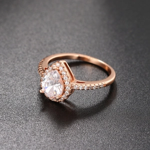 Detail of pear-cut zircon ring with halo setting and micro-pave diamonds in rose gold