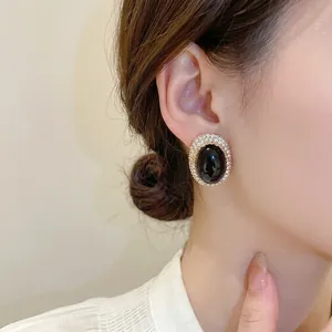 Vintage silver needle oval stud earrings with black stone and pavé crystal accents