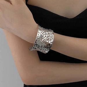 Detailed view of silver wide cuff bracelet with organic textured hollow patterns