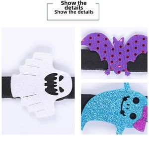 Detail showing glitter felt ghost, bat and monster charms on Halloween wristbands