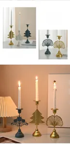 Detail of luxury metal candle holders with golden and blue floral镂空 carvings for tables