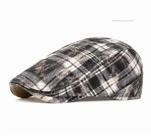 Detail of British style plaid beret showing black and white textured washed fabric
