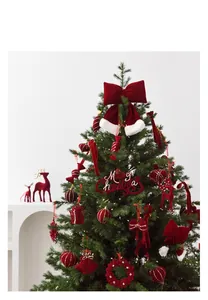 Detail of red flocked reindeer and ornaments hanging on a festive Christmas tree