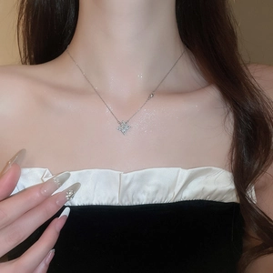 Close-up of sparkling star pendant necklace with small diamonds on silver chain