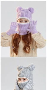 Close-up of kids' winter knit hood and gloves with fleece lining and fluffy pom-poms
