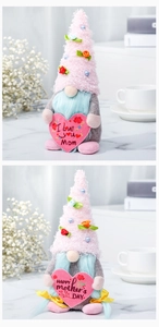 Macro shot of two Mother's Day faceless gnomes with hearts and pink plush hats