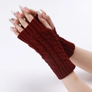 Close-up of wine red cable-knit fingerless arm warmers showing thick braided texture