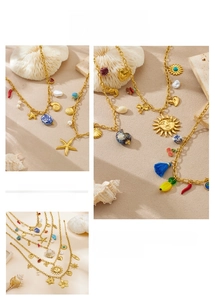 Close-up of gold stainless steel necklaces with ocean-themed shell and starfish charms