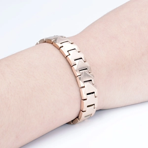 Detailansicht eines roségoldenen Magnetarmbands am Handgelenk eines männlichen Models