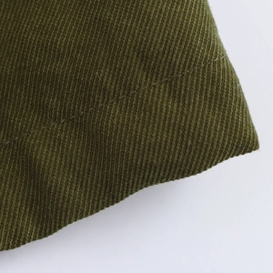 Detailed macro view of army green twill fabric texture and high-quality stitching detail