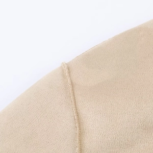 Macro shot of khaki knitted fabric showing precise shoulder stitching and material texture