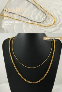 Detail of stainless steel necklace set with curb and twist chains in gold and silver finish