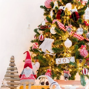 Dettaglio albero di Natale con nastri scozzesi bianchi e rossi e gnomi festivi