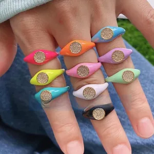 Close-up of colorful enamel copper rings with micro-pave crystals on model's hand