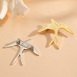 Titanium steel swallow bird brooch in gold and silver finish with detailed feathers