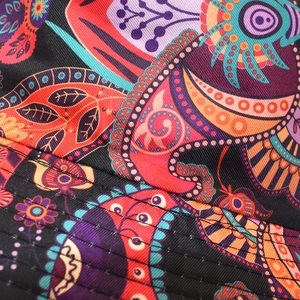 Detail of multi-color bohemian bucket hat brim featuring paisley patterns and reinforced stitching