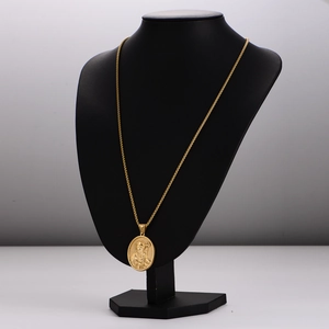Vintage gold round coin pendant necklace with embossed portrait on a neck model