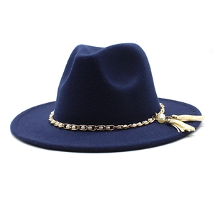 Detail of dark blue fedora hat with gold chain, white pearls and side tassel trim