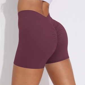 Detail of high waisted burgundy yoga shorts featuring scrunch butt lifting design