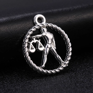 Detailed view of a silver Libra zodiac pendant with textured rope border and central scales motif