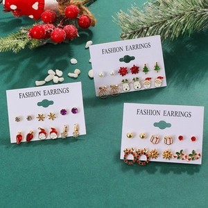 Festive Christmas earring set with Santa, reindeer, and tree studs on a white card