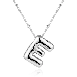 Macro shot of silver bubble letter E pendant on delicate bead chain with polished finish