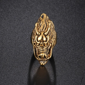 Detailed close-up of retro golden dragon head ring with intricate 3D carved textures