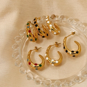 Golden C-shaped stainless steel enamel drop earrings set on champagne fabric
