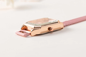 Close-up of square rose gold watch case and pink mesh magnetic strap from side view