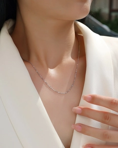 Elegant 925 sterling silver minimalist thin chain necklace worn over a white blazer