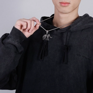 Detailed view of vintage silver elephant skull pendant necklace worn on a silver rope chain