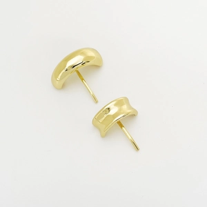 Close-up of golden curved bean stud earrings with a polished finish and smooth surface