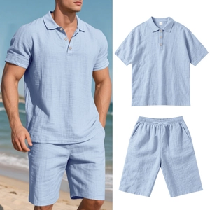 Detail of light blue linen polo set with drawstring shorts on beach background