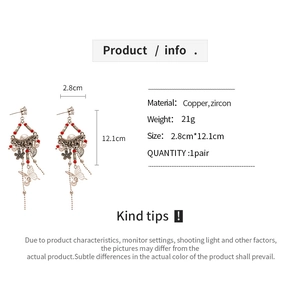 Detailed view of vintage bronze tassel earrings with butterfly motifs and red beads