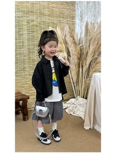 Detail shot of a stylish silver flap crossbody bag for girls with a chic outfit ensemble