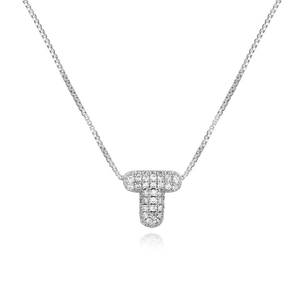 Macro detail of silver T-shaped pendant with cubic zirconia stones on a box chain
