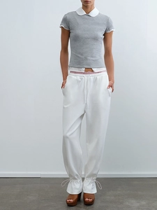 Detail of grey short sleeve knit top with white Peter Pan collar and white drawstring pants