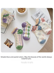 Detailed view of women's purple argyle and heart pattern cotton socks with ruffle cuffs