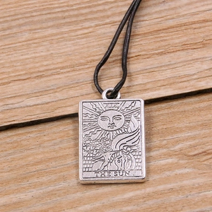 Silver zinc alloy tarot card pendant featuring The Sun design on a black cord necklace