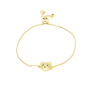 Gold-toned adjustable bolo bracelet featuring a pavé zircon bear head on white background