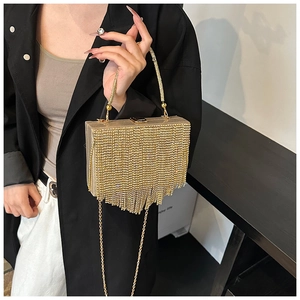 Detail of a luxury gold rhinestone fringe evening bag with shimmering tassel accents