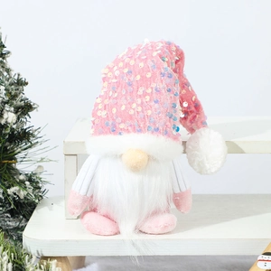 Pink sequined Christmas gnome doll with white beard on white tiered display stand