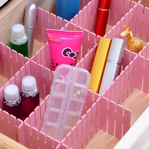 Pink adjustable plastic drawer dividers for organizing makeup and jewelry in drawers