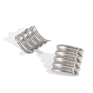 Macro detail of silver wavy textured rectangle earrings with a high-polished mirror finish