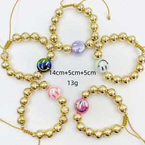 Detail of five-piece 18k gold plated beaded bracelets with colorful smiley face charms