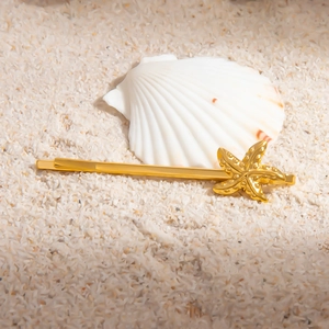 Minimalist 18K gold plated stainless steel starfish hair clip on sandy beach