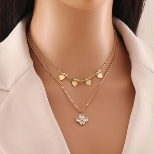 Double-layer gold necklace featuring star and clover pendants with crystal bead accents