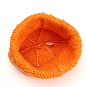 Bright orange ribbed knit beanie with reinforced inner stitching and wash label detail