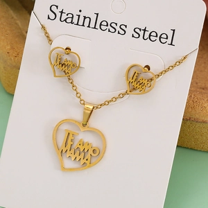 Detail of gold heart pendant necklace and earrings set with Te Amo Mama engraving